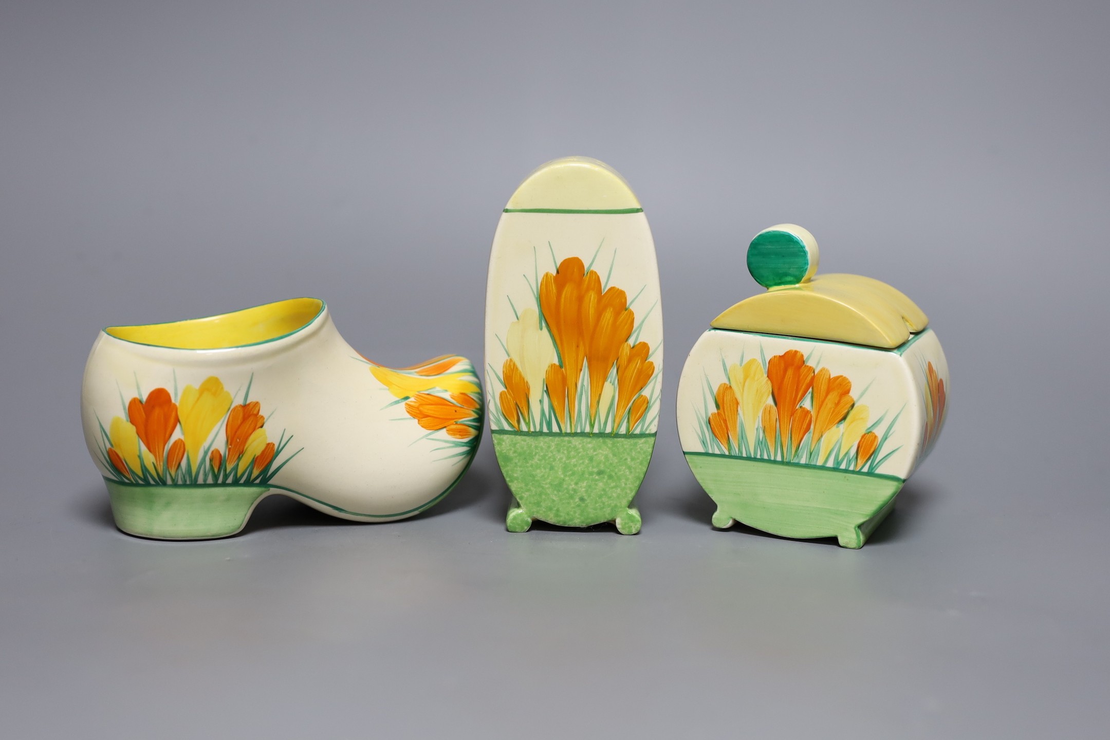 A Clarice Cliff sungleam crocus jam pot and cover, a sugar shaker and a Dutch clog ornament (3), jam pot and cover 10 cms high